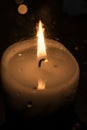 Candle burns at dusk, a candle fire on a black background Royalty Free Stock Photo