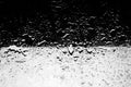 Water drops on glass, half black half white background