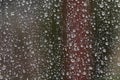 Water drops on the glass of a public transport stop in bad cloudy rainy weather Royalty Free Stock Photo
