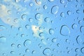 Water drops on glass window over blue sky. Water drops background Royalty Free Stock Photo