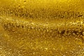 Water drops on golden glass background close up, gold droplets texture, abstract condensation pattern, shiny yellow backdrop Royalty Free Stock Photo