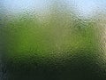 Water drops on green transparent glass close up Royalty Free Stock Photo