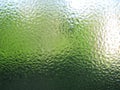 Water drops on green transparent glass close up Royalty Free Stock Photo