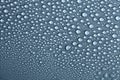 Water drops on light background, top view, close-up, macro. Great background with natural water drops and natural light Royalty Free Stock Photo