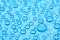 Water drops on light blue background, closeup Royalty Free Stock Photo