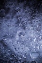 Water drops in macro in a dark violet background. Water drops in macro. Royalty Free Stock Photo