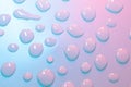 Water drops in neon lighting. Abstract unicorn colored background. Colorful texture backdrop Royalty Free Stock Photo