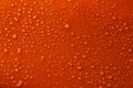 Water drops on orange background, close up Royalty Free Stock Photo