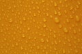 Water drops on orange background, top view Royalty Free Stock Photo