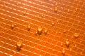 Water drops on orange plastic background texture Royalty Free Stock Photo