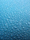 Water drops over blue plastic material