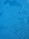 Water drops over blue plastic material