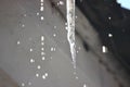 Water drops on the roof. icicles melt under influence of warm air and sun. Spring influence in the world. Modifying the pores of Royalty Free Stock Photo