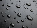 Water drops scattered on a dark, smooth surface. Royalty Free Stock Photo