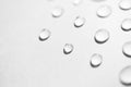 Water drops with selective focus on white background, macro. Concept moisturizing close-up. Aqua Royalty Free Stock Photo