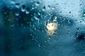 Water drops on the side window of the car. View from the inside of the car during the rain on the evening city street Royalty Free Stock Photo