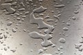 Water drops on silver metal table in harmonic form Royalty Free Stock Photo