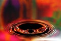 Water drops splash. Red and yellow ripples, reflections on surface Royalty Free Stock Photo