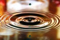 Water drops splash. Ripples and reflections on surface Royalty Free Stock Photo