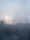 Water drops and sunlight on window glass Royalty Free Stock Photo