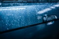 Water drops on the surface of a blue car Royalty Free Stock Photo