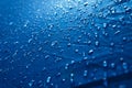 Water drops on waterproof nylon fabric. Macro detail view of texture of blue woven synthetic waterproof clothing. morning dew on Royalty Free Stock Photo