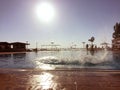 Water drops and wave and splash due to people jumping in a open air swimming pool Royalty Free Stock Photo