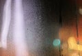 Water drops on wet window glass with city lights Royalty Free Stock Photo