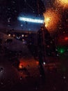 Water drops on the window, evening lights, beautiful colors, raining mood Royalty Free Stock Photo