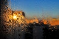 Water drops on a window glass after the rain. The sky with clouds and sun on background