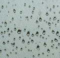 Water drops on window net mesh with cloudy sky on background Royalty Free Stock Photo