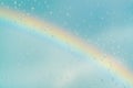 Water drops on a window with the rainbow in the background Royalty Free Stock Photo