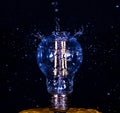 Water falling on a Light bulb Royalty Free Stock Photo