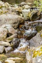 water falling over large rocks and small pebbles Royalty Free Stock Photo