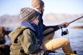 Water, father and son fishing in nature, outdoor and dad teaching boy in lake for bonding together. Parent, male person Royalty Free Stock Photo