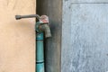 Water faucet with grass at outdoor house Royalty Free Stock Photo