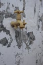 Water faucet planted on the wall with a stream of flowing water Royalty Free Stock Photo