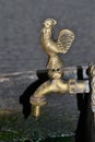 Water faucet or tap with a bronze figure of a rooster