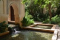 A Water Feature in a Garden With a Fountain, A tranquil Islamic-inspired garden with a serene water feature, AI Generated Royalty Free Stock Photo