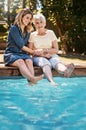 The water feels amazing. a happy senior woman spending quality time with her daughter at the pool. Royalty Free Stock Photo