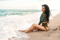 The water feels fantastic. a young beautiful woman in her bikini at the beach.