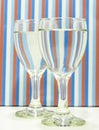 Water filled wine glasses abstractly placed.