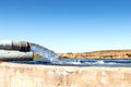 Water filling a cement dam outdoors on a farm