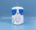 Water Flosser, Dental Oral Irrigator On Blue Background. Dental Equipment Care. Irrigator