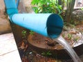 Water Flow from a Blue Pipe