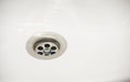Water flow into drain in white bath Royalty Free Stock Photo