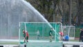 Water flow from a hose waters the field hockey stadium