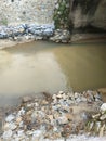 the water flow that looks a bit cloudy because of the tin mining waste Royalty Free Stock Photo