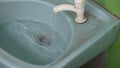 Water flowing continuously in a blue sink basin. Clean and refreshing concept.