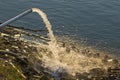 Water flowing from a drainage pipe into the river